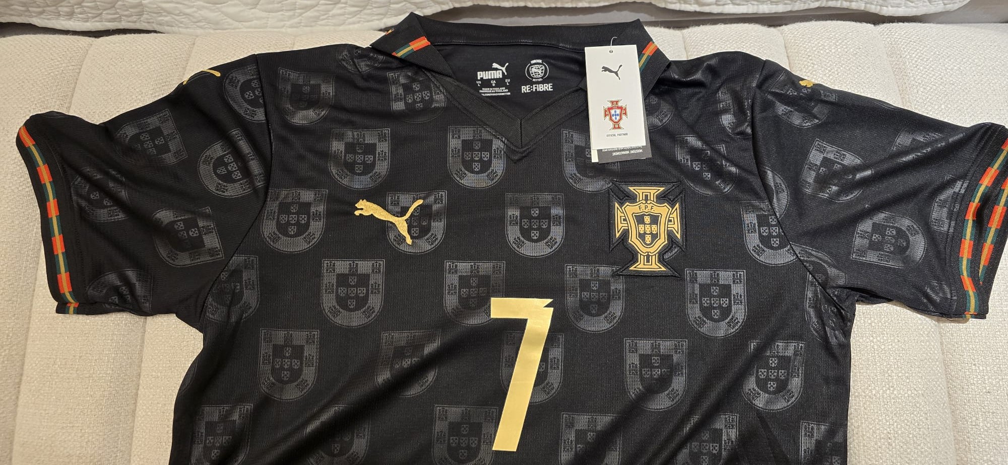 Portugal special edition black jersey with gold accents, number 7, and Puma branding